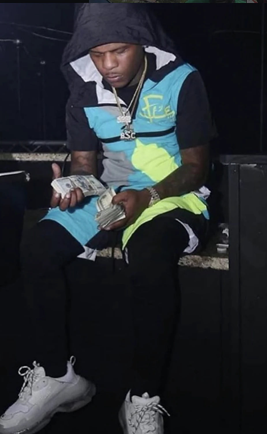 A man in a blue and neon F.LIFE colourblock jacket