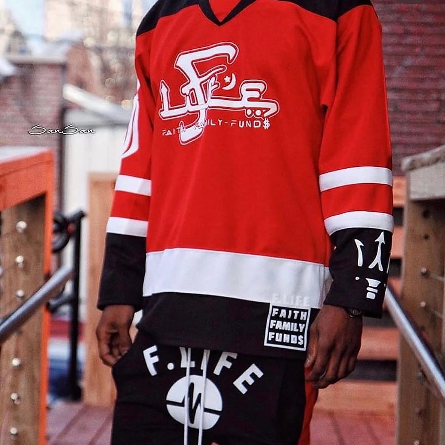 A red F.LIFE hockey jersey reading Faith Family Funds