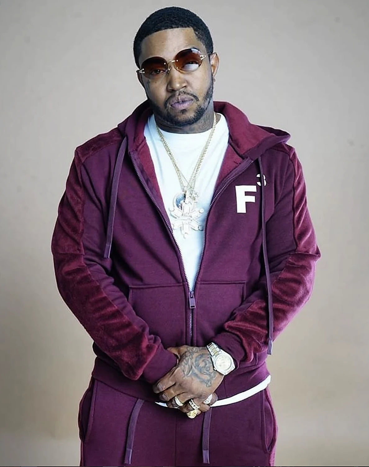 A man in a maroon F3 velour tracksuit