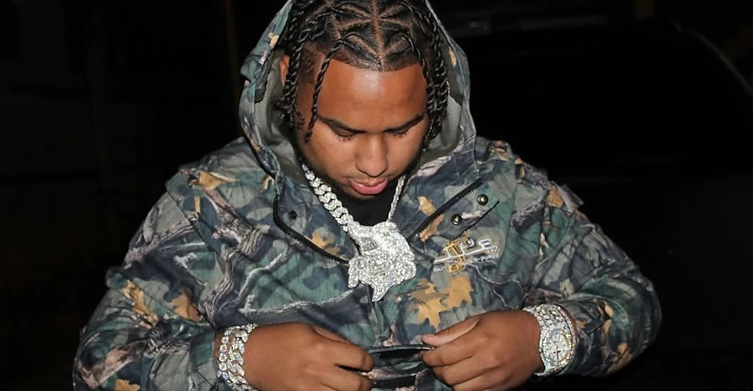 A man in a camo puffer wearing heavy chains
